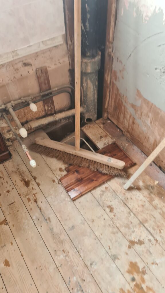 Rotten bathroom floor caused by a water leak in Cheltenham before repair